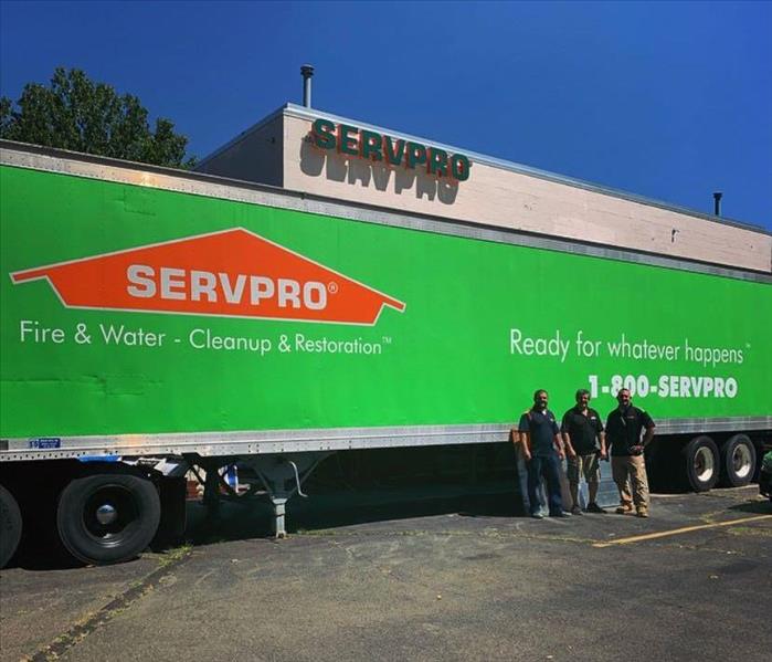 3 employees standing by our SERVPRO Truck 