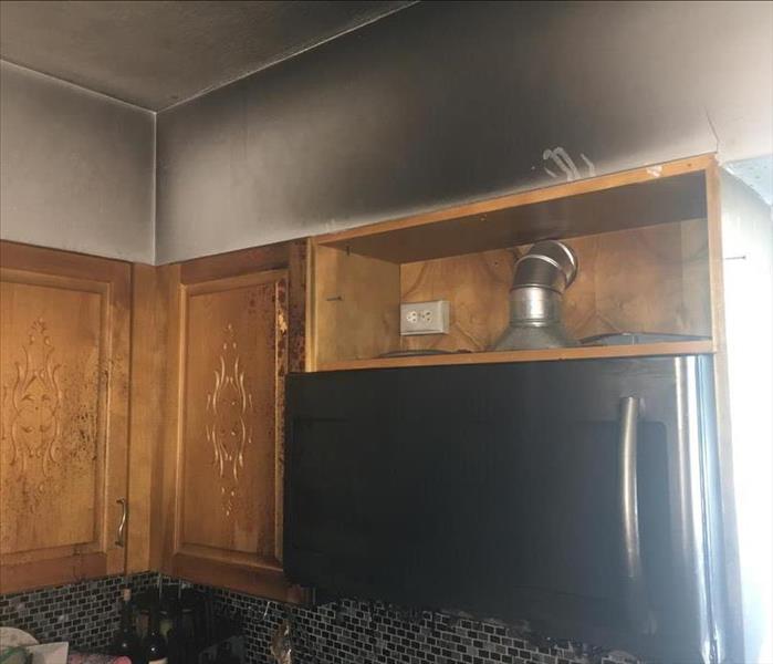 Dark discoloration on wall in kitchen from smoke damage as a result of a kitchen fire. 